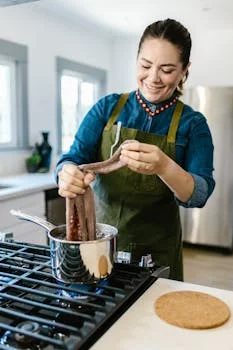 smiling female chef preparing dough